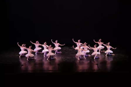 ballet dancers on a dark stage. 