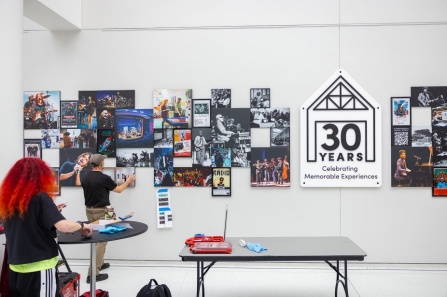 30 years mural being installed in the cfa atrium.
