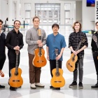 Six guitar players pose in the artirum of the Center for the Arts. 