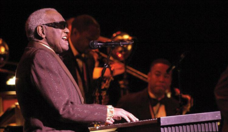 ray charles performing on piano at the center for the arts. 