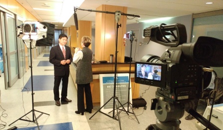 Video production set up with two people in a hallway.