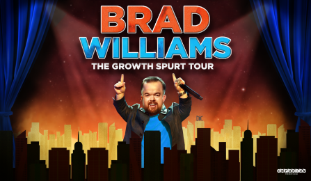 brad williams holding a microphone behind a city skyline. 