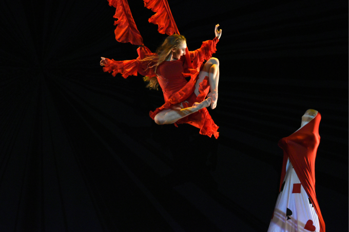 dancer suspended by cables from the ceiling. 