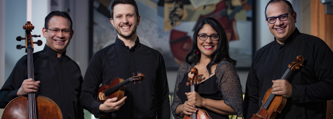 members of dali quartet posing with string instruments. 