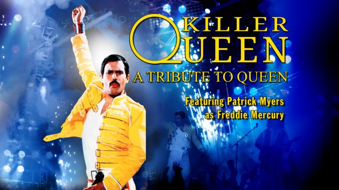Patrick Myers of Killer Queen dressed as Freddie Mercury with fist raised in the air. 