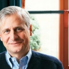 portrait of Jon Meacham sitting in front of a window. 