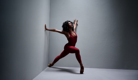 member of complexions posing in the corner of a room.